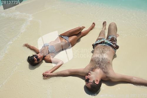 Image of happy young couple have fun on beach
