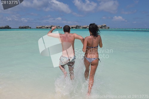 Image of happy young couple have fun on beach