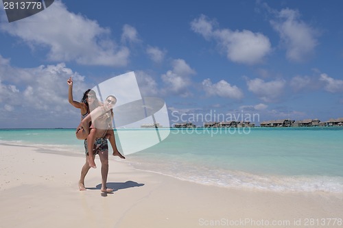 Image of happy young couple have fun on beach