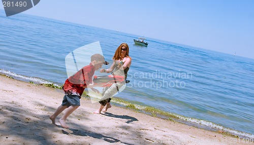 Image of Mother and Son playing at the beach