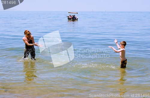 Image of Mother and Son playing at the beach