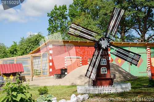 Image of colorful country yard mill in summer time 