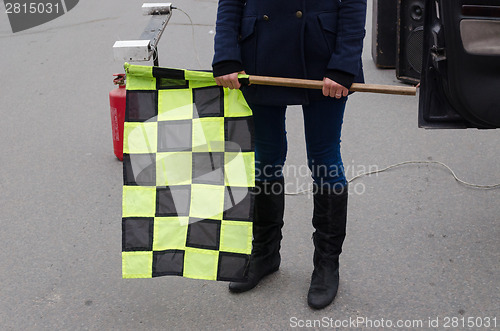 Image of hand hold checkered rally racing start flag 