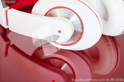 Image of White red headphones on vinous surface 