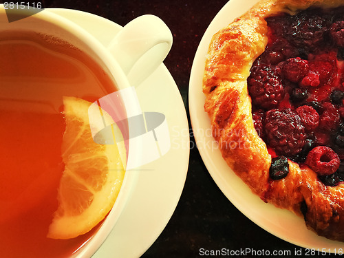 Image of Cup of tea with raspberry pastry
