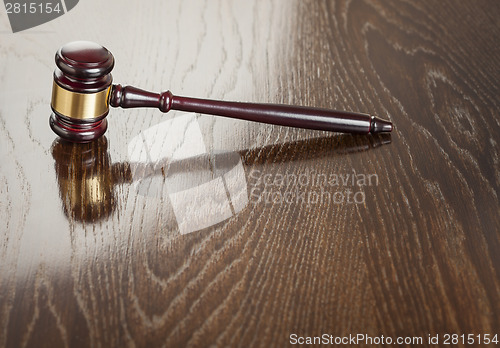 Image of Wooden Gavel Abstract on Reflective Table