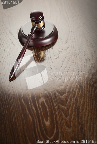 Image of Wooden Gavel Abstract on Reflective Table