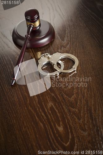 Image of Gavel and Pair of Handcuffs on Table