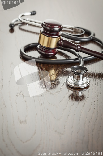 Image of Gavel and Stethoscope on Reflective Table