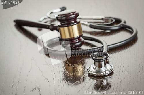 Image of Gavel and Stethoscope on Reflective Table