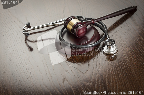 Image of Gavel and Stethoscope on Reflective Table