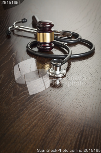 Image of Gavel and Stethoscope on Reflective Table