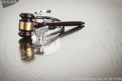 Image of Gavel and Stethoscope on Reflective Table