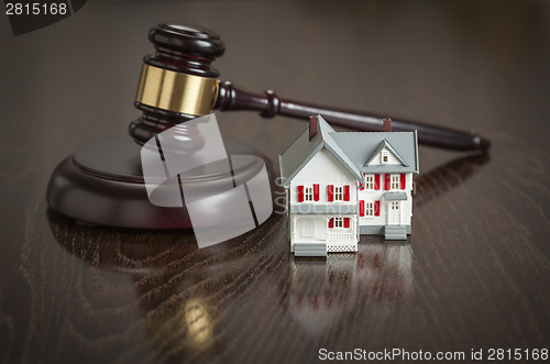 Image of Gavel and Small Model House on Table