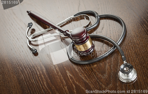 Image of Gavel and Stethoscope on Reflective Table