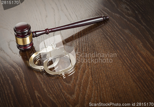 Image of Gavel and Pair of Handcuffs on Table