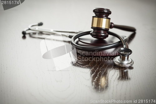 Image of Gavel and Stethoscope on Reflective Table