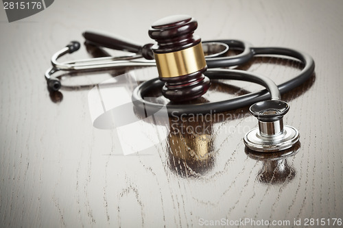 Image of Gavel and Stethoscope on Reflective Table