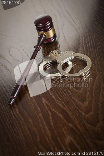 Image of Gavel and Pair of Handcuffs on Table