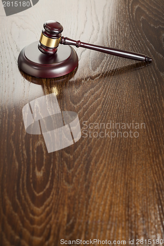 Image of Wooden Gavel Abstract on Reflective Table