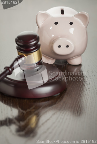 Image of Gavel and Piggy Bank on Table