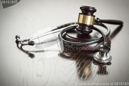 Image of Gavel and Stethoscope on Reflective Table