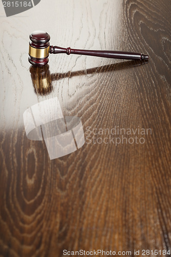 Image of Wooden Gavel Abstract on Reflective Table