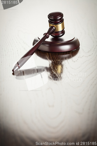 Image of Wooden Gavel Abstract on Reflective Table
