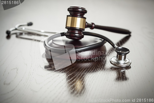 Image of Gavel and Stethoscope on Reflective Table