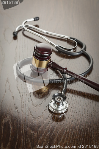 Image of Gavel and Stethoscope on Reflective Table
