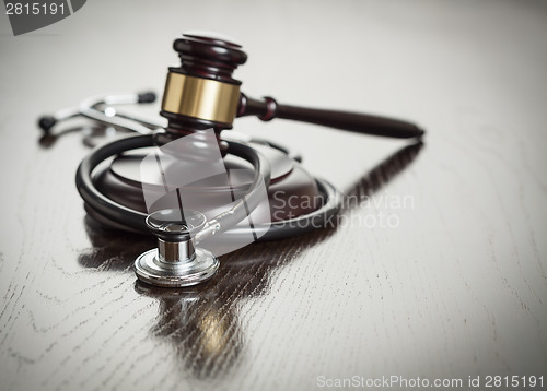 Image of Gavel and Stethoscope on Reflective Table