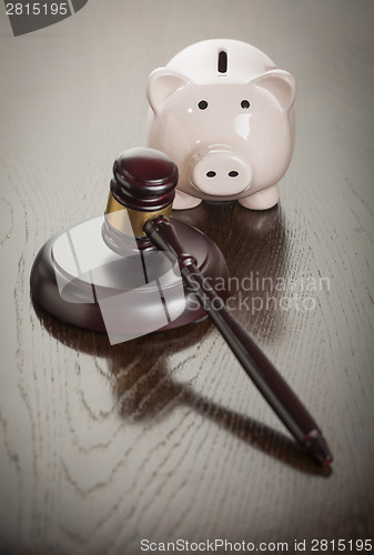 Image of Gavel and Piggy Bank on Table