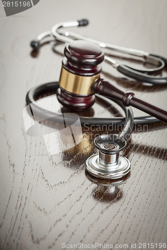 Image of Gavel and Stethoscope on Reflective Table