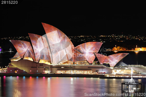 Image of Sydney Opera House lit with vibrant colours and patterns during 