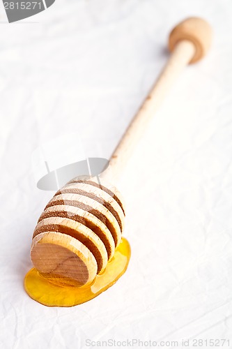 Image of honey on wooden honey dipper