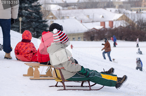 Image of children sit wooden sledge ready slide from hill 