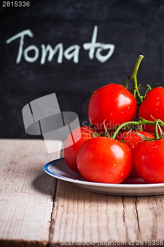 Image of fresh tomatoes and blackboard