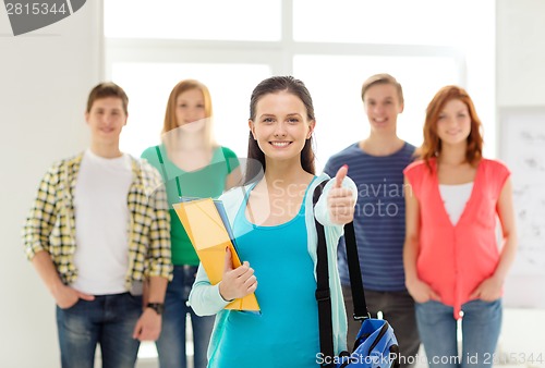 Image of smiling students with teenage girl in front