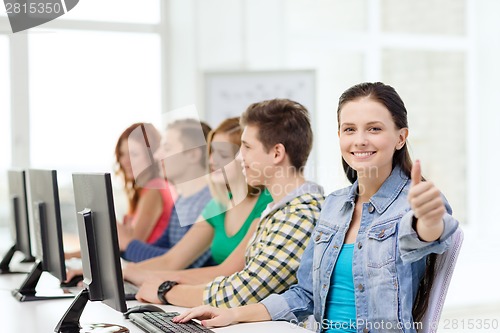 Image of female student with classmates in computer class