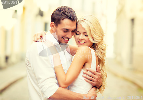 Image of romantic happy couple hugging in the street