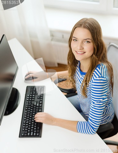 Image of dreaming teenage girl with computer at home