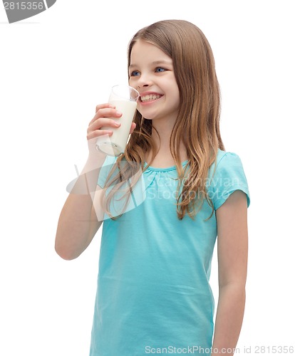 Image of smiling little girl drinking milk out of glass