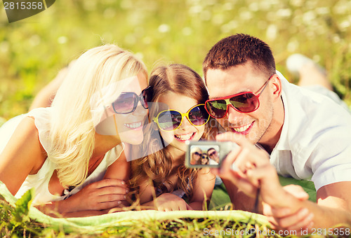 Image of happy family with camera taking picture