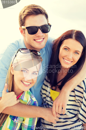 Image of group of friends having fun on the beach