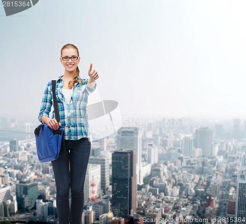 Image of student with laptop bag showing thumbs up
