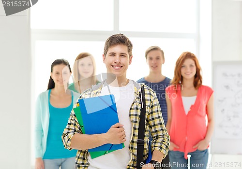 Image of smiling students with teenage boy in front