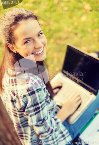 Image of smiling teenager with laptop