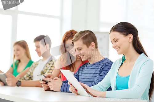 Image of smiling students with tablet pc at school