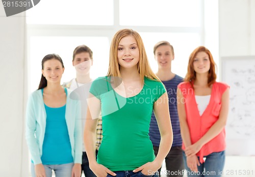 Image of smiling students with teenage girl in front