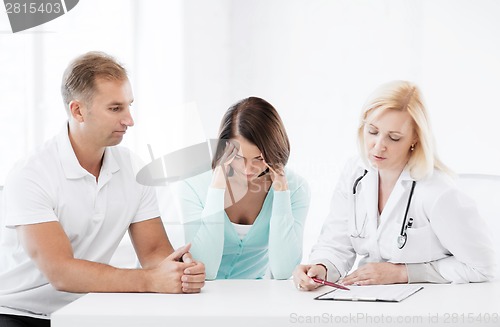 Image of doctor with patients in cabinet